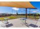 Shaded bocce ball court with tables, chairs and a manicured green playing surface at 5624 S Winchester --, Mesa, AZ 85212