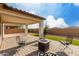 Inviting covered patio with tiled floor, seating, and a fire pit for outdoor relaxation at 5624 S Winchester --, Mesa, AZ 85212