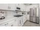 Bright kitchen with white countertops, stainless steel refrigerator, and tiled floors at 5624 S Winchester --, Mesa, AZ 85212