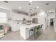 Bright kitchen featuring white cabinetry, stainless steel appliances, and a large center island with seating at 5624 S Winchester --, Mesa, AZ 85212