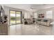 Bright living room featuring neutral colors, tile flooring, and sliding glass doors at 5624 S Winchester --, Mesa, AZ 85212