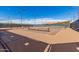 Well-maintained tennis court with nets in place, surrounded by fencing and clear blue skies at 5624 S Winchester --, Mesa, AZ 85212