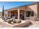 Inviting back patio featuring comfortable seating areas, desert landscaping, and outdoor grill at 5705 S Pinnacle Ln, Gold Canyon, AZ 85118