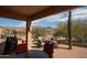 Covered back patio with views of the desert landscaping and mountain scenery at 5705 S Pinnacle Ln, Gold Canyon, AZ 85118