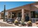 Back patio featuring outdoor seating, lush desert landscaping, and cozy grill, perfect for entertaining at 5705 S Pinnacle Ln, Gold Canyon, AZ 85118