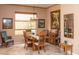 Dining room featuring a wooden table set, neutral walls, framed artwork, and a large bright window with views of the outside at 5705 S Pinnacle Ln, Gold Canyon, AZ 85118