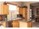 Eat-in kitchen featuring granite countertops, wood cabinets, a stainless steel dishwasher, and a window with views of the outside at 5705 S Pinnacle Ln, Gold Canyon, AZ 85118