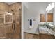 Bathroom featuring a glass-enclosed shower with tile surround and vanity with granite countertop at 5914 E Dale Ln, Cave Creek, AZ 85331