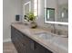 Dual sink bathroom vanity with sleek dark cabinets, light countertop, and modern lighting at 5914 E Dale Ln, Cave Creek, AZ 85331