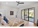 Bright bedroom with a patterned bedspread and a sliding glass door that looks out to a patio and backyard at 5914 E Dale Ln, Cave Creek, AZ 85331