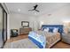 Bright bedroom with a patterned bedspread, wood floors, and a sliding glass door at 5914 E Dale Ln, Cave Creek, AZ 85331