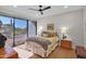 Bedroom with a patterned bedspread, wood floors, and a sliding glass door with desert views at 5914 E Dale Ln, Cave Creek, AZ 85331