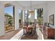 Bright dining room with hardwood floors and large windows overlooking the lush desert landscape at 5914 E Dale Ln, Cave Creek, AZ 85331