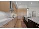 Contemporary kitchen featuring light wood cabinetry, a farmhouse sink, and white marble countertops at 5914 E Dale Ln, Cave Creek, AZ 85331