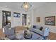 Bright living room featuring modern decor, neutral-toned furniture, hardwood floors, and an elegant chandelier at 5914 E Dale Ln, Cave Creek, AZ 85331