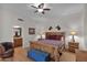 Cozy bedroom with wood accents, decorative horse head art, and an adjacent bathroom at 5914 E Dale Ln, Cave Creek, AZ 85331