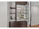 Elegant built-in wine fridge and storage with shelves for glasses and drinks at 5914 E Dale Ln, Cave Creek, AZ 85331