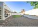 Landscaped backyard featuring a patch of grass, rock ground cover, and a covered patio at 6014 W Bent Tree Dr, Phoenix, AZ 85083