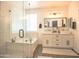 A modern bathroom with a soaking tub and a glass shower at 6014 W Bent Tree Dr, Phoenix, AZ 85083