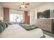 A primary bedroom featuring a gray upholstered bed, wood dresser, and exercise equipment at 6014 W Bent Tree Dr, Phoenix, AZ 85083