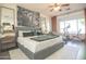 A primary bedroom featuring a gray upholstered bed, wood dresser, and exercise equipment at 6014 W Bent Tree Dr, Phoenix, AZ 85083