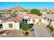 Beautiful single-story home with a red tile roof, mature landscaping, and circular driveway in a mountain backdrop community at 6014 W Bent Tree Dr, Phoenix, AZ 85083