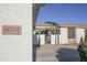 Exterior shot of the house number with a walkway leading to a wrought-iron gate and an outdoor pergola at 6014 W Bent Tree Dr, Phoenix, AZ 85083