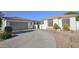 Home exterior featuring a well-manicured landscape with a variety of trees and shrubs at 6014 W Bent Tree Dr, Phoenix, AZ 85083