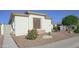 A well-maintained front yard featuring a variety of desert plants and stucco exterior at 6014 W Bent Tree Dr, Phoenix, AZ 85083