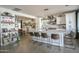 Bright, modern eat-in kitchen with large island, bar seating, white cabinetry, and stainless steel appliances at 6014 W Bent Tree Dr, Phoenix, AZ 85083