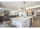 Open-concept kitchen with a large island, modern lighting, and view of the living room at 6014 W Bent Tree Dr, Phoenix, AZ 85083