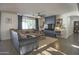 Bright living room features a ceiling fan, a built-in entertainment center, and seamless access to the patio at 6014 W Bent Tree Dr, Phoenix, AZ 85083