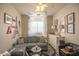 Charming living room with a gray sectional sofa, whimsical decor, and ample natural light for a cozy feel at 6014 W Bent Tree Dr, Phoenix, AZ 85083