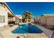 The backyard has a pool, desert landscaping, with a covered patio and seating at 635 W Douglas Ave, Gilbert, AZ 85233