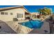 Backyard pool with desert landscaping, offers a private oasis for relaxation and entertaining at 635 W Douglas Ave, Gilbert, AZ 85233