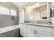 Bathroom featuring a shower/tub combo, granite vanity, and modern lighting at 635 W Douglas Ave, Gilbert, AZ 85233