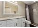 Bathroom features a white vanity with granite countertops, and a tiled shower with a semi-frameless glass door at 635 W Douglas Ave, Gilbert, AZ 85233