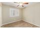 Second bedroom featuring plantation shutters and modern laminate flooring at 635 W Douglas Ave, Gilbert, AZ 85233