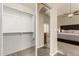 Walk-in closet with ample storage space, seen from the main bedroom at 635 W Douglas Ave, Gilbert, AZ 85233