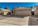 Charming single-story home featuring a well-manicured desert landscape, neutral stucco exterior, and a tile roof at 635 W Douglas Ave, Gilbert, AZ 85233