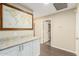 Hallway with modern cabinets, stone countertop, a decorative wall map, and dark hardwood flooring at 635 W Douglas Ave, Gilbert, AZ 85233