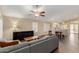 Open-concept living room and dining area showcasing hardwood floors, natural light, and a modern ceiling fan at 635 W Douglas Ave, Gilbert, AZ 85233