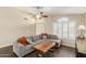 Inviting living room with hardwood floors, large windows, vaulted ceilings, and a modern ceiling fan at 635 W Douglas Ave, Gilbert, AZ 85233