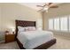 Bright main bedroom featuring a large bed, vaulted ceilings, and plantation shutters at 635 W Douglas Ave, Gilbert, AZ 85233