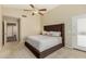 Comfortable main bedroom featuring a large bed, neutral tones, and a ceiling fan at 635 W Douglas Ave, Gilbert, AZ 85233