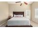 Inviting main bedroom featuring a large bed, neutral tones, and a ceiling fan at 635 W Douglas Ave, Gilbert, AZ 85233