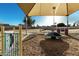 Community playground featuring covered play structures, a merry-go-round, and safety surfacing at 635 W Douglas Ave, Gilbert, AZ 85233