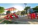 Community park featuring a vibrant playground with climbing structures, slides, and shade canopies at 635 W Douglas Ave, Gilbert, AZ 85233