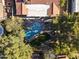 Aerial shot of backyard with a freeform pool and lush landscaping at 7607 E Charter Oak Rd, Scottsdale, AZ 85260