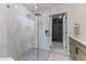 Elegant bathroom with glass shower, tiled walls and floors, and walk-in closet at 7607 E Charter Oak Rd, Scottsdale, AZ 85260